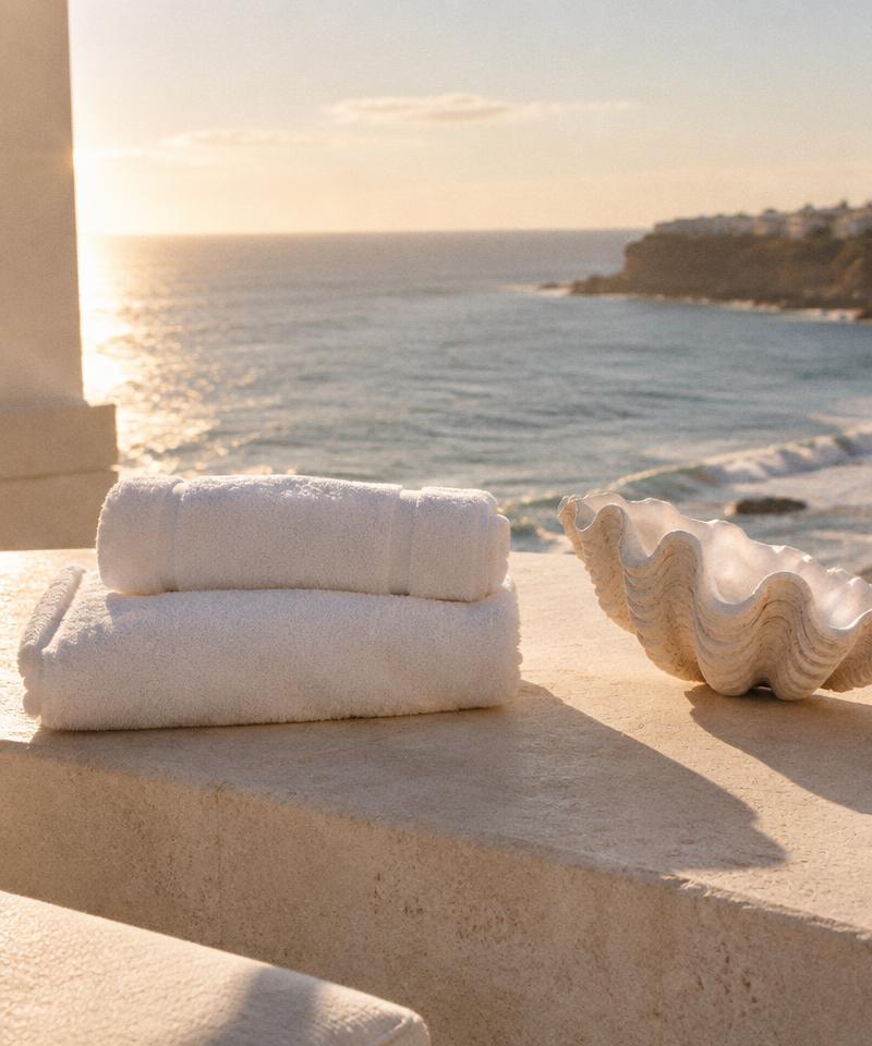Fresh towels beside a sunlit ocean view
